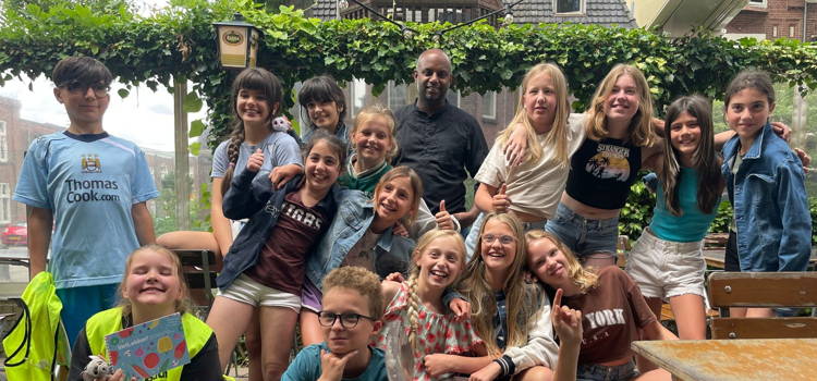 Groepsfoto van kinderen bij restaurant
